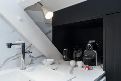 a bathroom with a white counter with a sink at Charming flat - Nice port in Nice