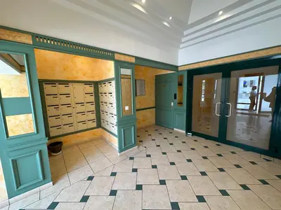 a room with green doors and a tiled floor at Stunning Studio Rue France Promenade des Anglais in Nice