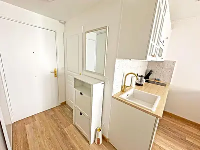 a small white kitchen with a sink and a mirror at Stunning Studio Rue France Promenade des Anglais in Nice
