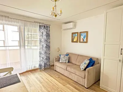 a living room with a couch and a window at Stunning Studio Rue France Promenade des Anglais in Nice