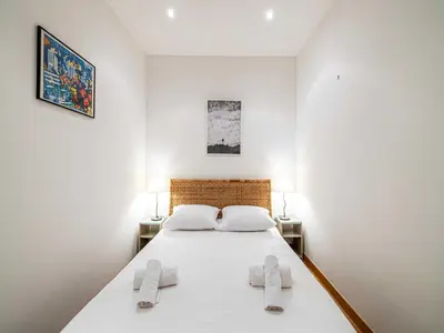 a bedroom with a large white bed with two towels at Superb 2 room apartment in the heart of Nice in Nice