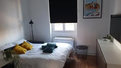 a bedroom with a bed with two pillows on it at Studio au cœur de Nice lumineux in Nice