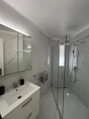 a white bathroom with a shower and a sink at Superbe appartement Port de Nice Lumineux,Clim , Parking in Nice