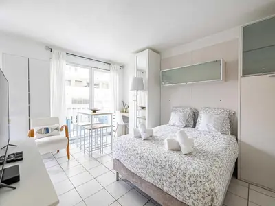 a bedroom with a bed and a table and a chair at Studio with balcony & pool -Heart of Nice in Nice