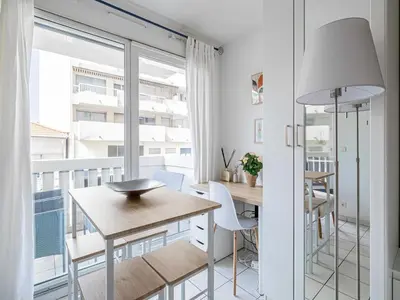 a dining room with a table and chairs and a balcony at Studio with balcony & pool -Heart of Nice in Nice