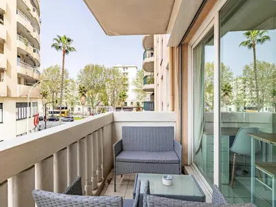 a balcony with a chair and a table at Studio with balcony & pool -Heart of Nice in Nice