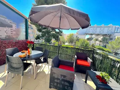 a patio with a table and chairs and an umbrella at ⁂ Studio cosy 3 min de la plage terrasse clim in Nice