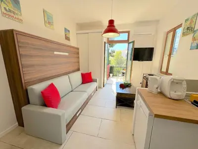 a living room with a white couch and red pillows at ⁂ Studio cosy 3 min de la plage terrasse clim in Nice