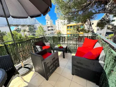 a patio with chairs and an umbrella and a table at ⁂ Studio cosy 3 min de la plage terrasse clim in Nice