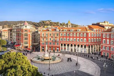 a city with a fountain in front of buildings at ⁂ Studio cosy 3 min de la plage terrasse clim in Nice