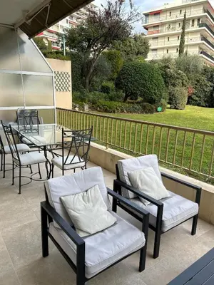 a balcony with chairs and tables and a table and chairs at Le Grand Soleil in Nice