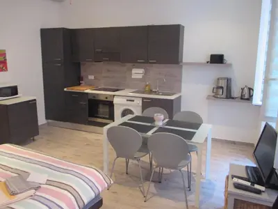 a kitchen with a table and chairs in a room at Nice Studio Old Town Sea Side in Nice