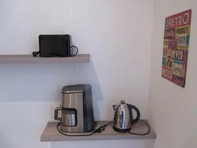 a coffeemaker and a coffee maker on a shelf at Nice Studio Old Town Sea Side in Nice