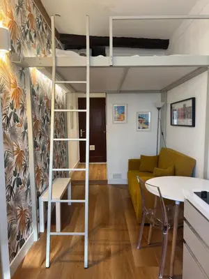 a living room with a loft bed and a table at Studio nel cuore della città in Nice