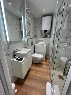 a white bathroom with a toilet and a sink at Studio nel cuore della città in Nice