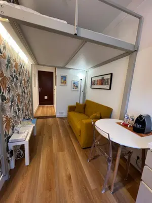 a living room with a yellow couch and a table at Studio nel cuore della città in Nice