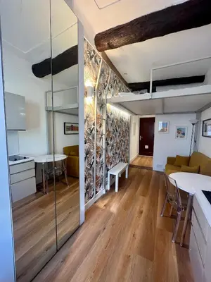 a kitchen and living room with a glass wall at Studio nel cuore della città in Nice