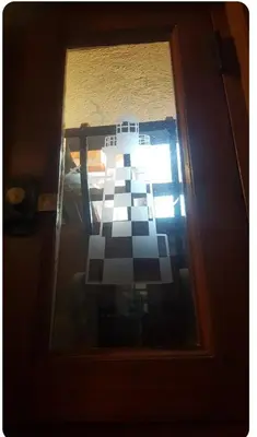 a glass door with a checkerboard pattern on it at Chambre au calme sur les collines in Nice