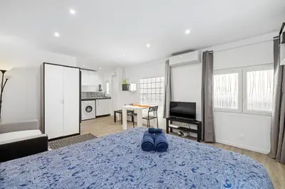 a bedroom with a bed and a room with a tv at Nice Renting - PENCHIENATTI - Chic & Modern Urban Pearl Massena Old Nice in Nice