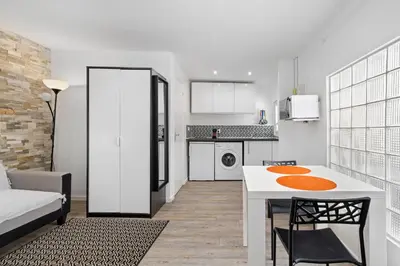 a kitchen and living room with a table and chairs at Nice Renting - PENCHIENATTI - Chic & Modern Urban Pearl Massena Old Nice in Nice
