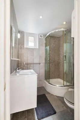a bathroom with a sink and a shower and a toilet at Nice Renting - PENCHIENATTI - Chic & Modern Urban Pearl Massena Old Nice in Nice