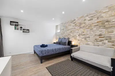 a living room with a bed and a couch at Nice Renting - PENCHIENATTI - Chic & Modern Urban Pearl Massena Old Nice in Nice