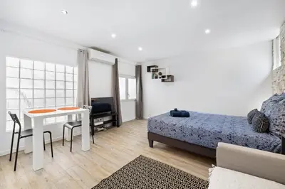 a bedroom with a bed and a table and a bed and a table and chairs at Nice Renting - PENCHIENATTI - Chic & Modern Urban Pearl Massena Old Nice in Nice