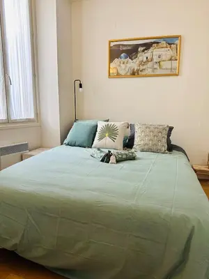a bedroom with a large bed with a green comforter at New ! Charmant spacieux 2p Vieux-Nice calme in Nice