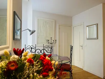 a dining room with a glass table and flowers at New ! Charmant spacieux 2p Vieux-Nice calme in Nice