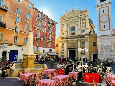 a group of people sitting in chairs around a fountain at New ! Charmant spacieux 2p Vieux-Nice calme in Nice