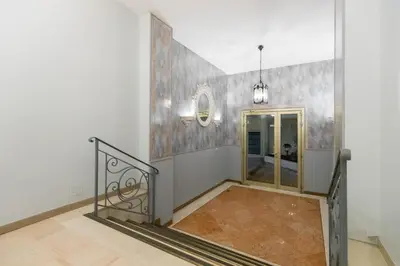 a hallway with a staircase in a white room at Superbe studio Nice hyper centre immeuble standing in Nice