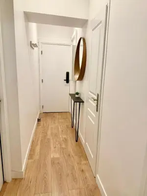 a hallway with a door and a table and a mirror at Magnifique 2 pièces - Vieux Nice in Nice