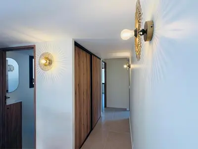 a hallway with a ceiling fan and a door at L'Esprit Sud, 4 Suites & Piscine Chauffée in Vence