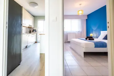 a bedroom with a bed and a blue wall at Sea & City View in Nice