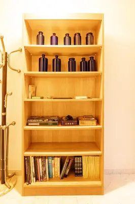 a wooden book shelf with books and cups at Sea & City View in Nice