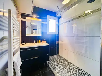 a blue bathroom with a sink and a shower at Evasion vue mer - Wifi, Piscine, Parking, 4pers in Nice