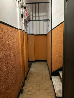 a corridor of a hallway with a tile floor at Studio climatisé in Nice