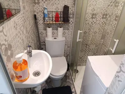 a small bathroom with a toilet and a sink at Studio climatisé in Nice