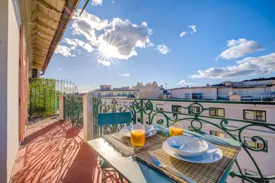 a balcony with a table with plates of food on it at Maison Bianchi - Avenue Durante - Downtown Top floor in Nice