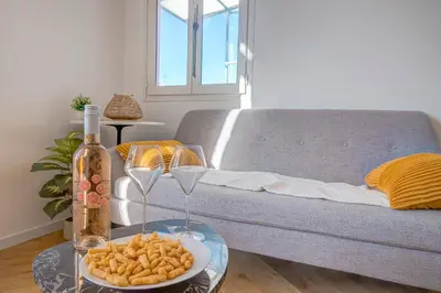 a table with a plate of food and a bottle of wine at Maison Bianchi - Avenue Durante - Downtown Top floor in Nice