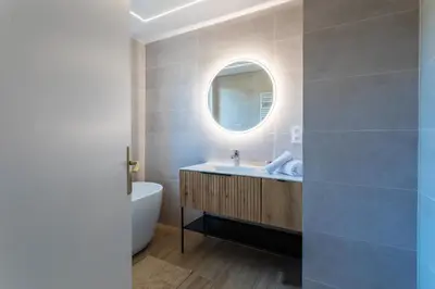 a bathroom with a sink and a tub and a mirror at LE SAINT ESTEVE AP4435 By Riviera Holiday Homes in Villefranche-sur-Mer