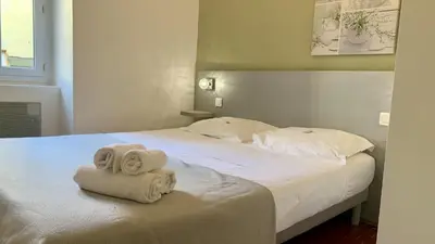 a bedroom with a bed with towels on it at ApartHotel Riviera - COCON BARILLERIE - Old Town - Promenade des Anglais in Nice