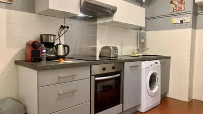 a kitchen with a washing machine and a washer at ApartHotel Riviera - COCON BARILLERIE - Old Town - Promenade des Anglais in Nice