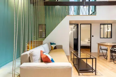 a living room with a couch and a table at Loft Spacieux pour 10 personnes avec Terrasse in Nice