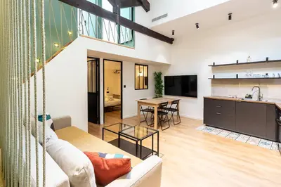 a living room with a couch and a table at Loft Spacieux pour 10 personnes avec Terrasse in Nice