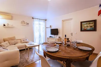 a living room with a table and a couch at HEAVEN AP4440 By Riviera Holiday Homes in Villefranche-sur-Mer