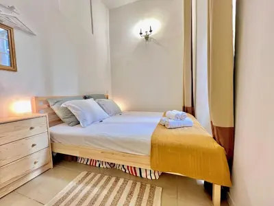a small bedroom with a bed and a dresser at ApartHotel Riviera - MAISON DU CHATEAU - Old town - Promenade des Anglais in Nice