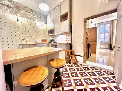 a kitchen with a counter and stools at ApartHotel Riviera - MAISON DU CHATEAU - Old town - Promenade des Anglais in Nice