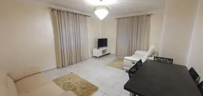 a living room with a couch and a tv in it at Appartement 3 pièces sur Nice Centre in Nice
