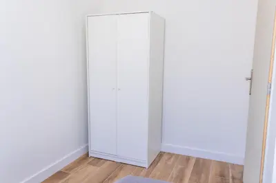 a white door in a room with a wooden floor at NIce proche mer in Nice